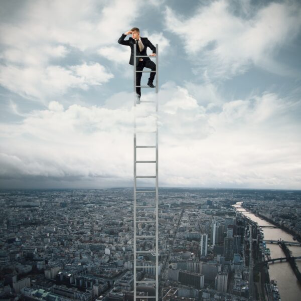 man looking for a job standing to ladder